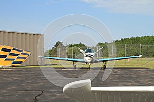 Small prop aircraft at airport on tarmac