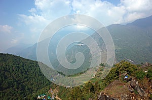 Small propeller airplane flying from Tenzingâ€“Hillary Airport in Lukla Nepal