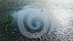 Small puddles on the asphalt road after rain