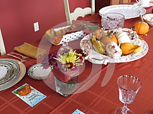 Small pumpkins and gourds of various colors, displayed on platters from various angles and depth