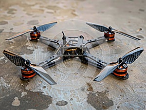 A small quadcopter with orange and black propellers photo