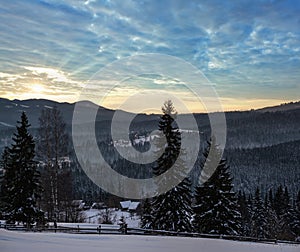 Small and quiet alpine village and winter sunrise snowy mountains around, Voronenko, Carpathian, Ukraine