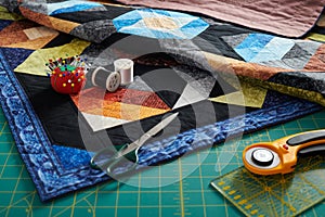 Small quilt, cutting mat and sewing and quilting accessories