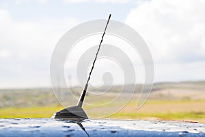 Small radio antenna on the roof of a car