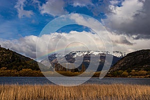 A small rainbow between the mountain and the lagoon