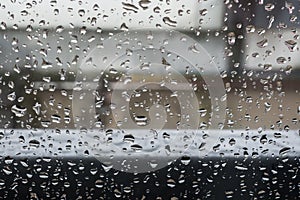 Small raindrops on glass in inclement weather photo