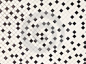 Small random black and white small ceramic tiles background, on diagonal.