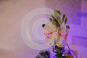 Small real Christmas tree decorated with hugging bears. Christmas decorations and toys. New Year atmosphere. Holiday background