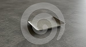 A small, rectangular tray rests on a smooth, gray stone or ceramic surface. The tray