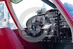 Small red airplane pilot`s cabin on a sunny day