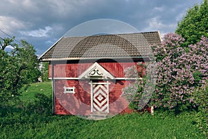 a small red barn near Lake Mjosa in Norway on a spring day