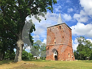 A small red brick countryside church in northern Poland