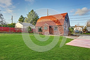 Small red brick home on a sunny day