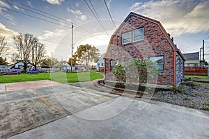 Small red brick home on a sunny day