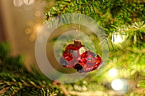 Small red car bauble on Christmas tree. Xmas decoration.