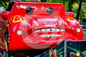 Small red car with face in amusement park