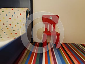 Small red chair in ihe dollhouse