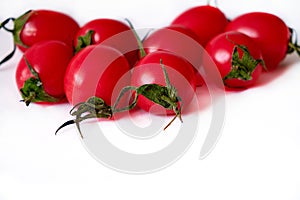 Small red cherry tomatoes on a white background