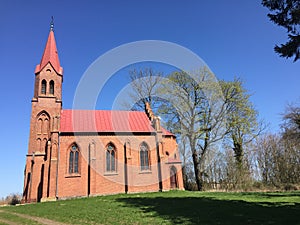 Red church on a hill in Strzepowo Poland