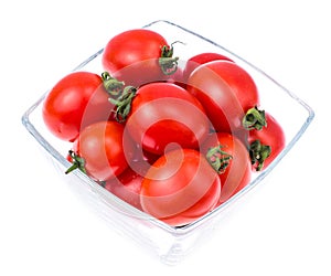 Small red cocktail tomatoes in glass bowl