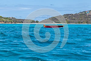 Small Red Empty Boat on Tropical Water