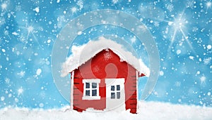 Small red house model covered with snow