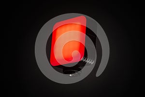 Small red LED light panel isolated on dark background for creative lighting
