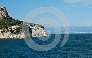 A small Red Lighthouse marks the rocks on the east coast of Istria in Croatia