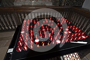 Small red lit church prayer candles