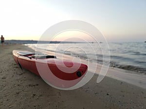 Small red rescue canoe stops on the beach