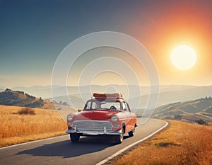 A small red retro car drives off into the distance towards the hills above which there is a huge orange sun, tourist suitcases on