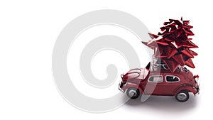 Small red retro car Volkswagen Beetle with celebration bow on white