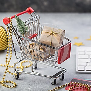 Small red shopping cart with keyboard for Internet online shopping concept christmas gifts. save