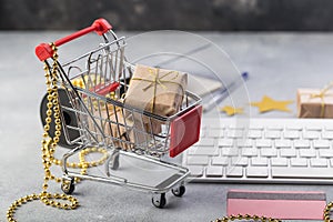 Small red shopping cart with keyboard for Internet online shopping concept christmas gifts. save