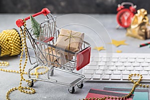 Small red shopping cart with keyboard for Internet online shopping concept christmas gifts. save