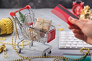 Small red shopping cart with keyboard for Internet online shopping concept christmas gifts. save