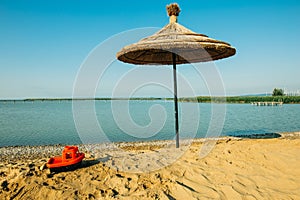 Small red toy boat on beack of lake neusiedler am see in breitenbrunn