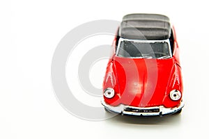 small red toy car on white
