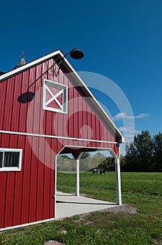 Small red vinyl sided run in shelter shed for horse on farm