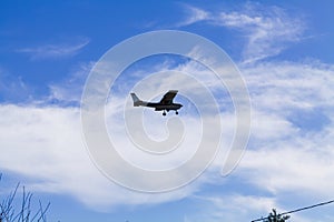 Small Red And White Prop Plane In Blue Sky With Clouds