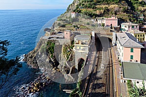 Small regional train station, located between mountains, at Riomaggiore town in Cinque Terre national park, Italy