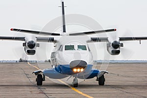 A small regional turboprop airplane at the airport apron