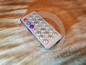 Small remote control on blurry background