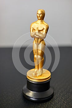 A small replica of the Oscar figure. A symbol of achievements in cinema. Selective focus