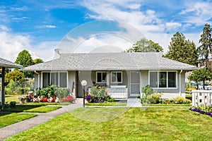 Small residential duplex house with concrete pathway over front yard