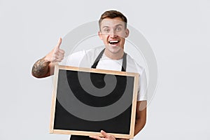 Small retail business owners, cafe and restaurant employees concept. Enthusiastic friendly and upbeat salesman in black