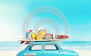 Small retro car with baggage, luggage and beach equipment on the roof, fully packed, ready for summer vacation