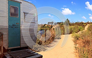 Small retro caravan camper used as a tiny house on road trips