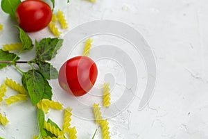 small ripe tomatoes, fresh basil ,pasta top view flat lay frame