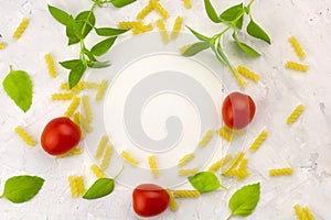 Small ripe tomatoes, fresh basil ,pasta top view